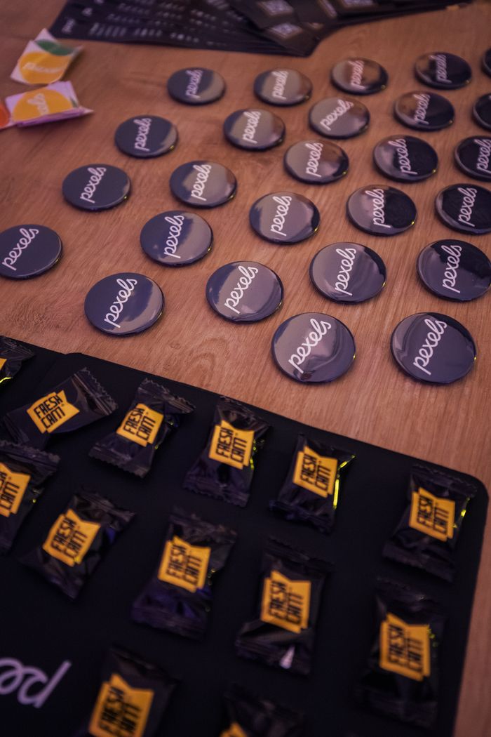 Crafting Captivating Headlines: Your awesome post title goes here Display of branded buttons and candies at a marketing event.